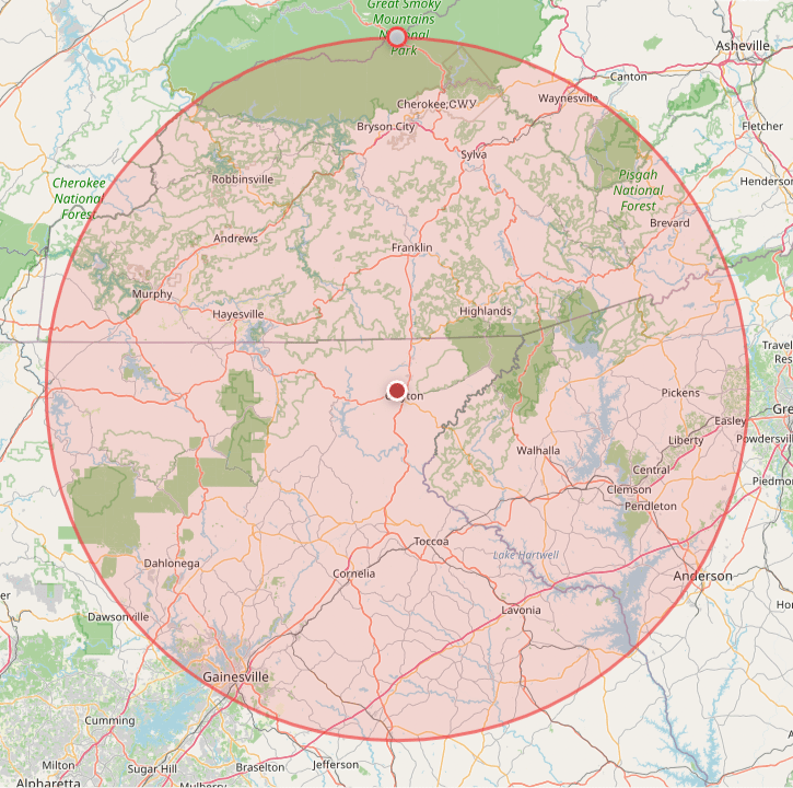 Map showing a circular red radius around a central point in Alabama, with towns and roads inside the circle.